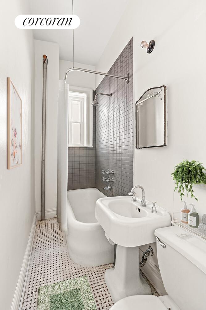 175 Prospect Park Southwest, Unit 1A Brooklyn, NY 11218 - Photo 5 of 9 a bathroom with a sink a toilet and shower