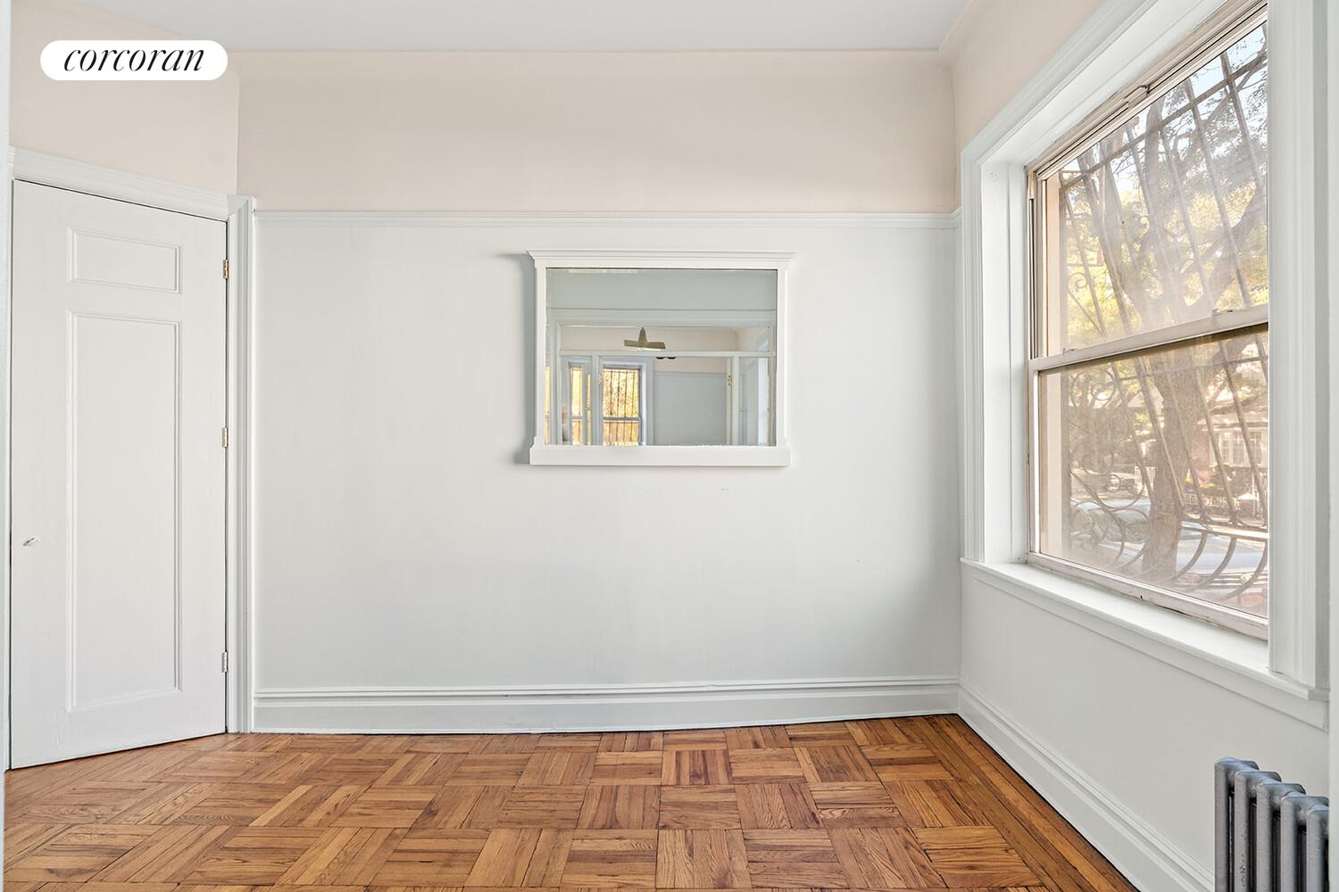 175 Prospect Park Southwest, Unit 1A Brooklyn, NY 11218 - Photo 8 of 9 a view of an empty room with a window