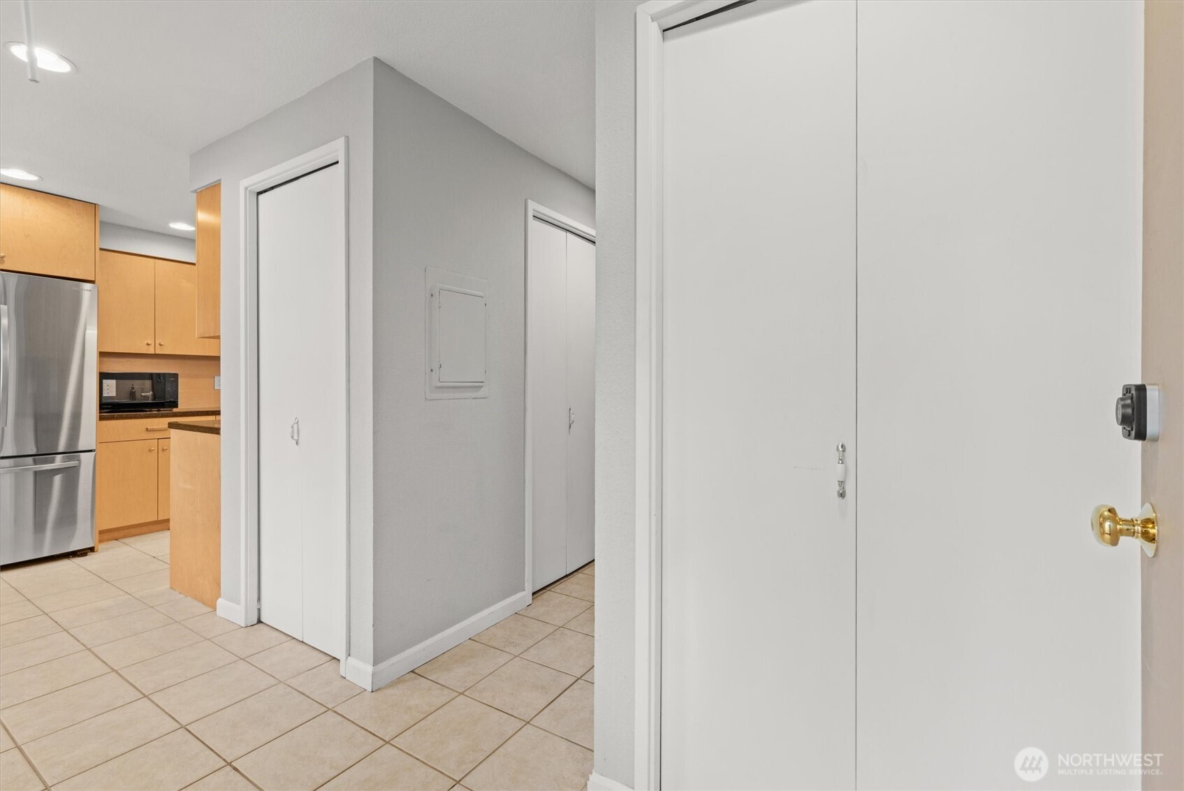 8225 212th Street Southwest, Unit 304 Edmonds, WA 98026 - Photo 2 of 35 a view of a kitchen from the hallway