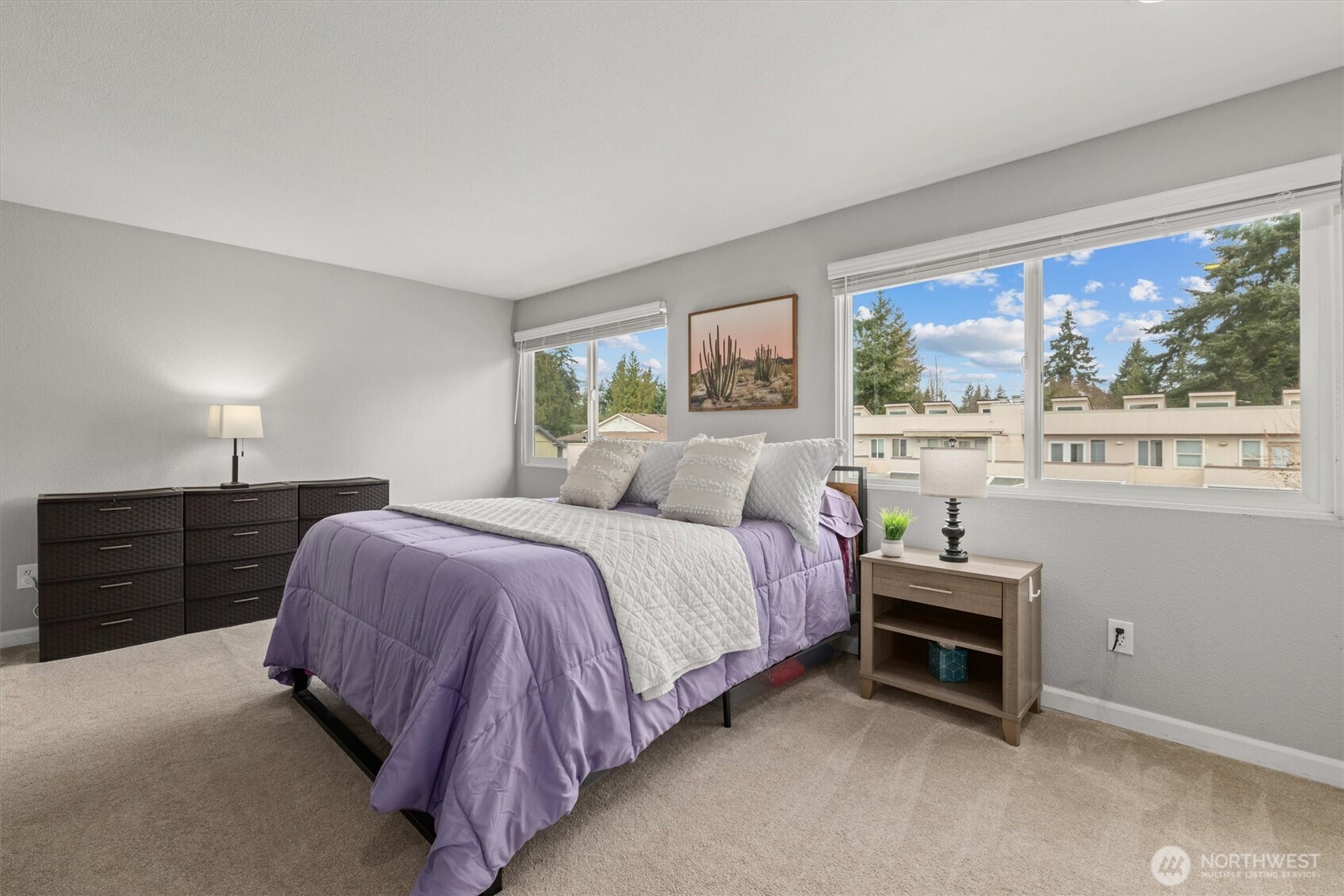 8225 212th Street Southwest, Unit 304 Edmonds, WA 98026 - Photo 22 of 35 a bedroom with a bed and a large window