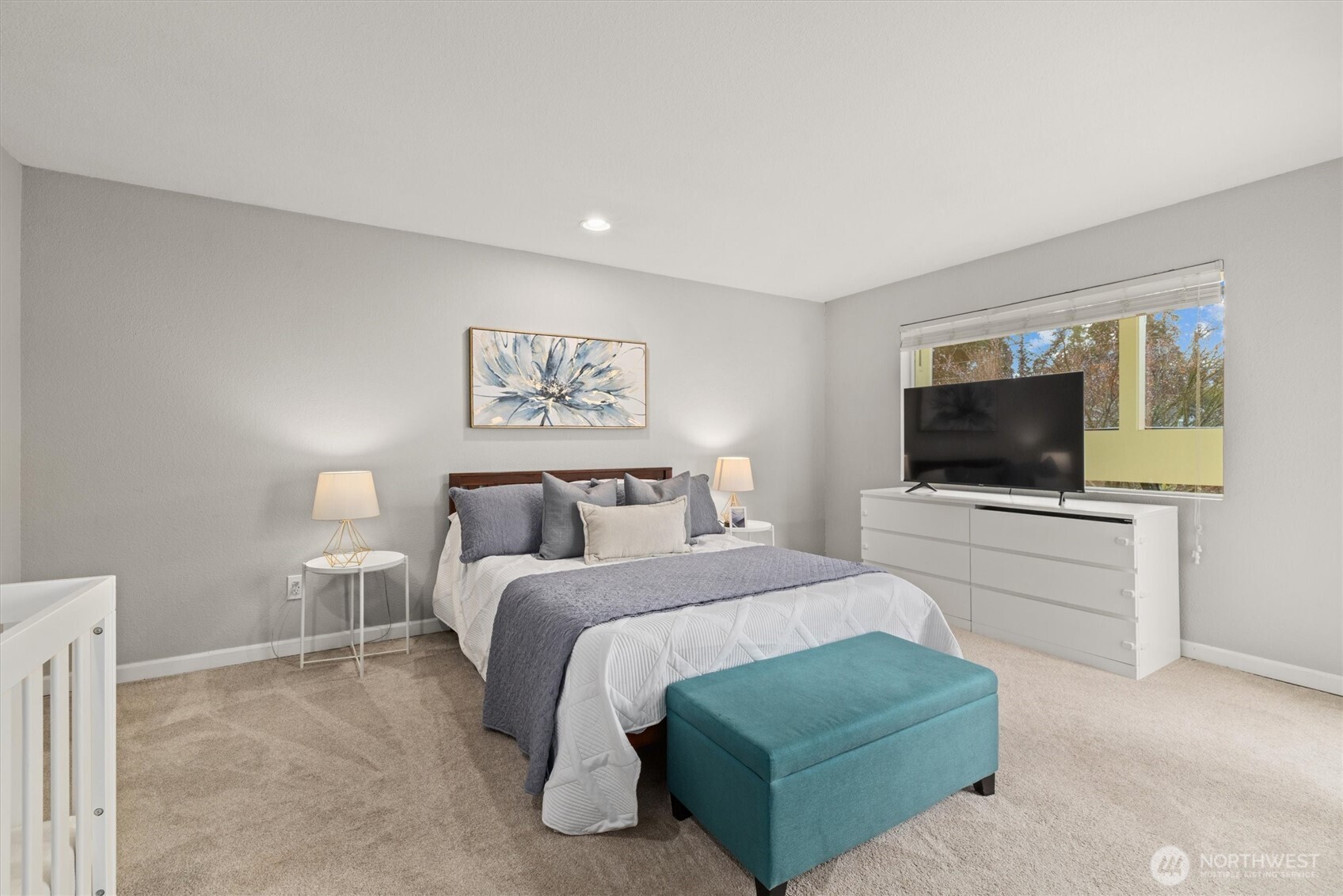 8225 212th Street Southwest, Unit 304 Edmonds, WA 98026 - Photo 24 of 35 a bedroom with a bed and a flat screen tv