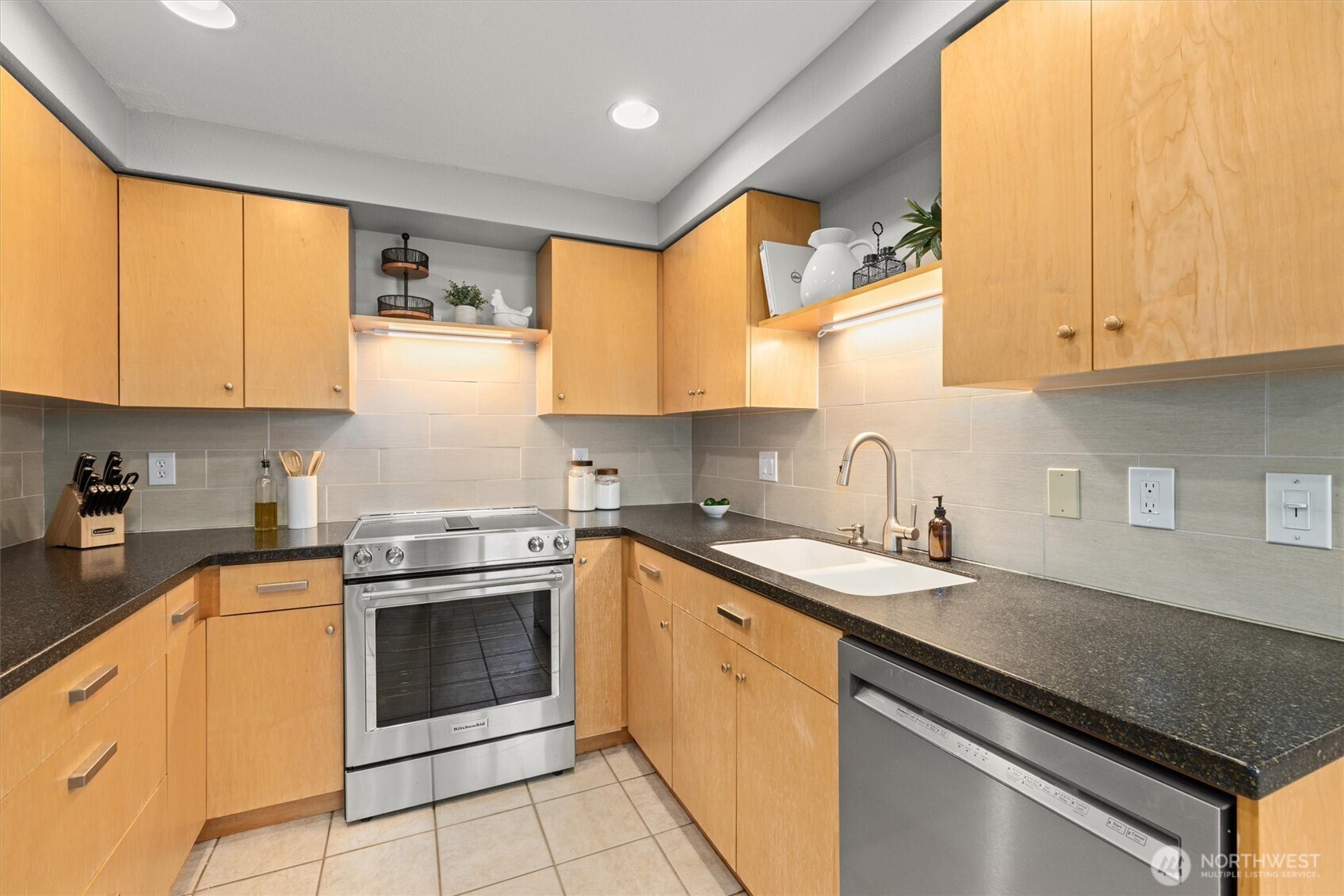 8225 212th Street Southwest, Unit 304 Edmonds, WA 98026 - Photo 3 of 35 a kitchen with stainless steel appliances granite countertop a sink stove and cabinets