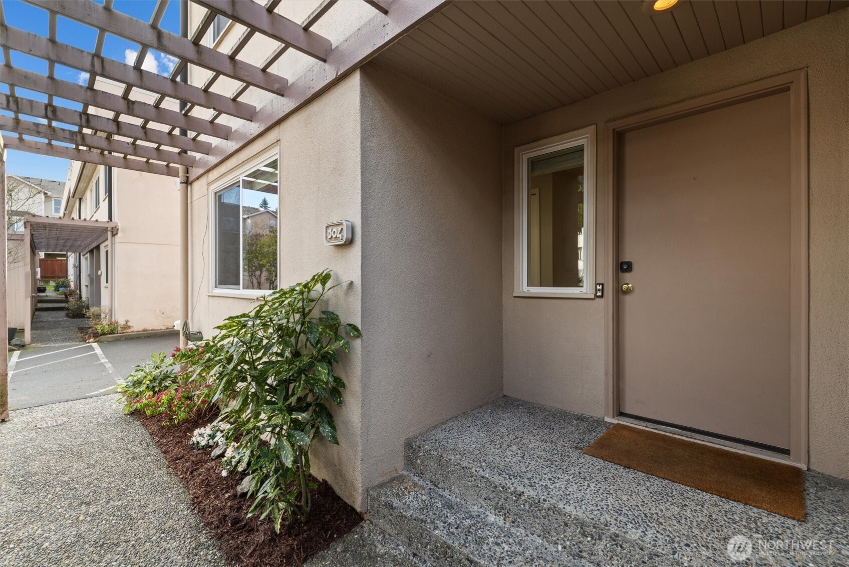 8225 212th Street Southwest, Unit 304 Edmonds, WA 98026 - Photo 31 of 35 a entryway view with a potted plant in front of it