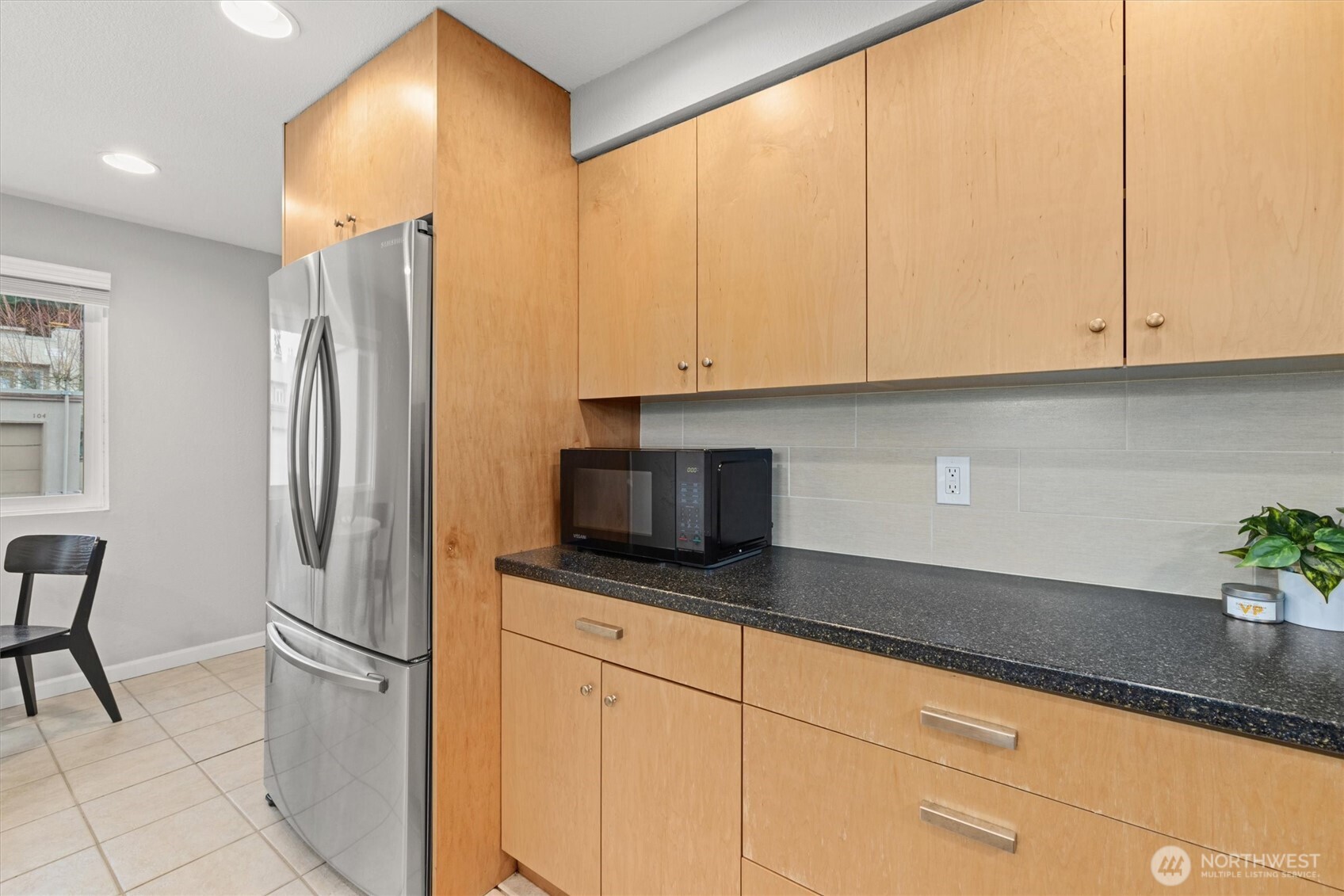 8225 212th Street Southwest, Unit 304 Edmonds, WA 98026 - Photo 5 of 35 a kitchen with stainless steel appliances a refrigerator sink and cabinets