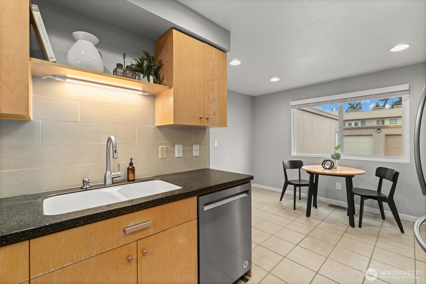 8225 212th Street Southwest, Unit 304 Edmonds, WA 98026 - Photo 6 of 35 a kitchen with a sink and a stove top oven