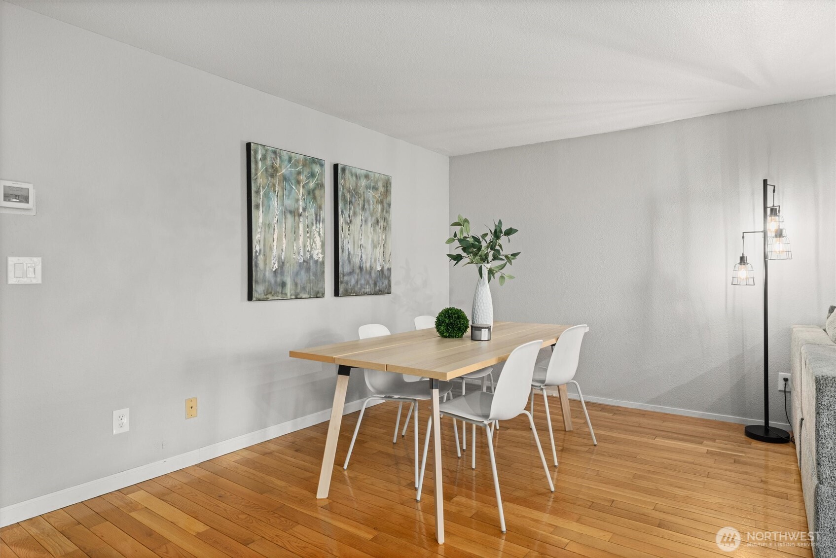 8225 212th Street Southwest, Unit 304 Edmonds, WA 98026 - Photo 9 of 35 a view of a dining room with furniture and wooden floor