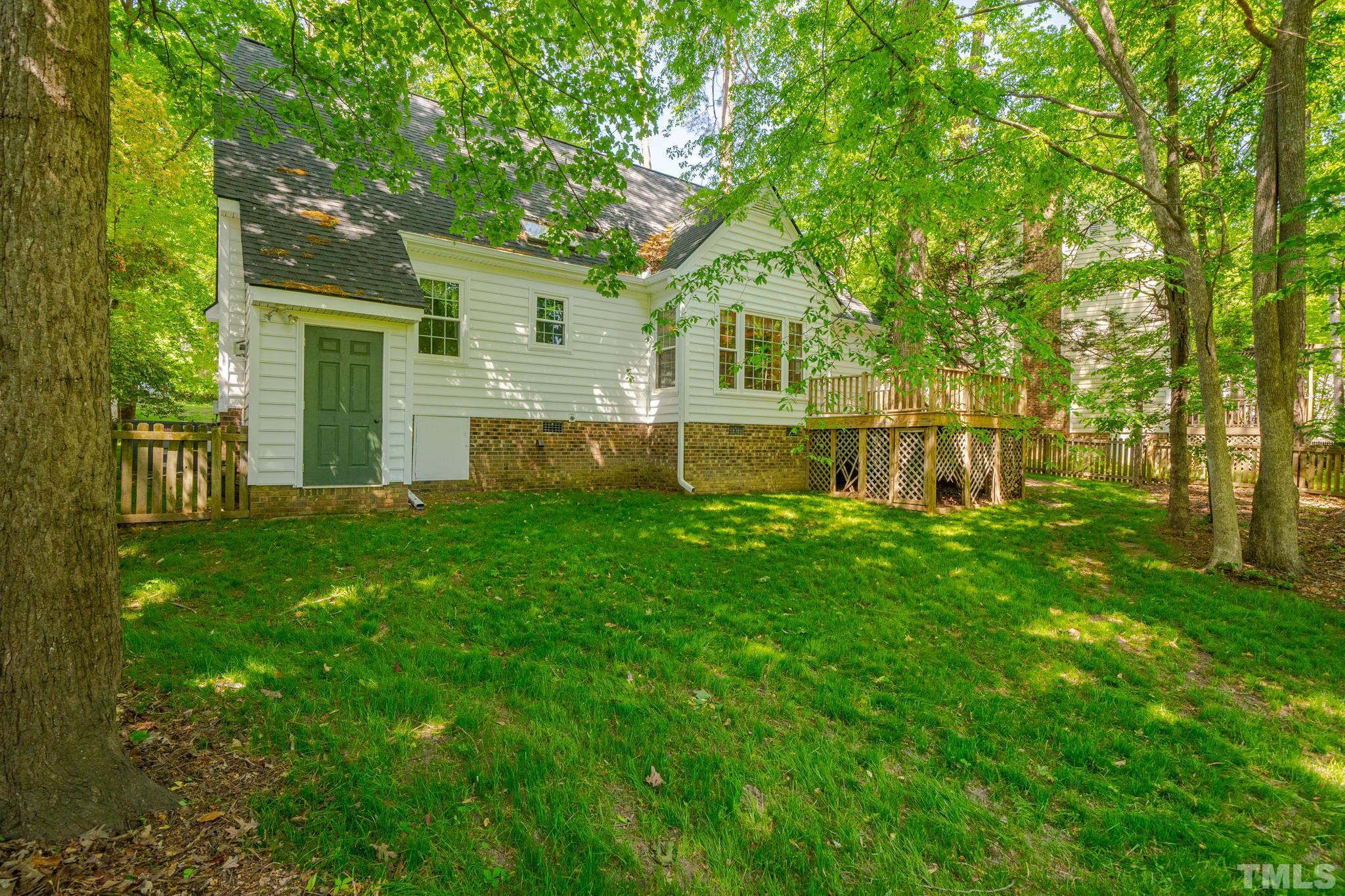 8704 Master Court Raleigh, NC 27615 - Photo 10 of 20 a view of a house with backyard and a tree