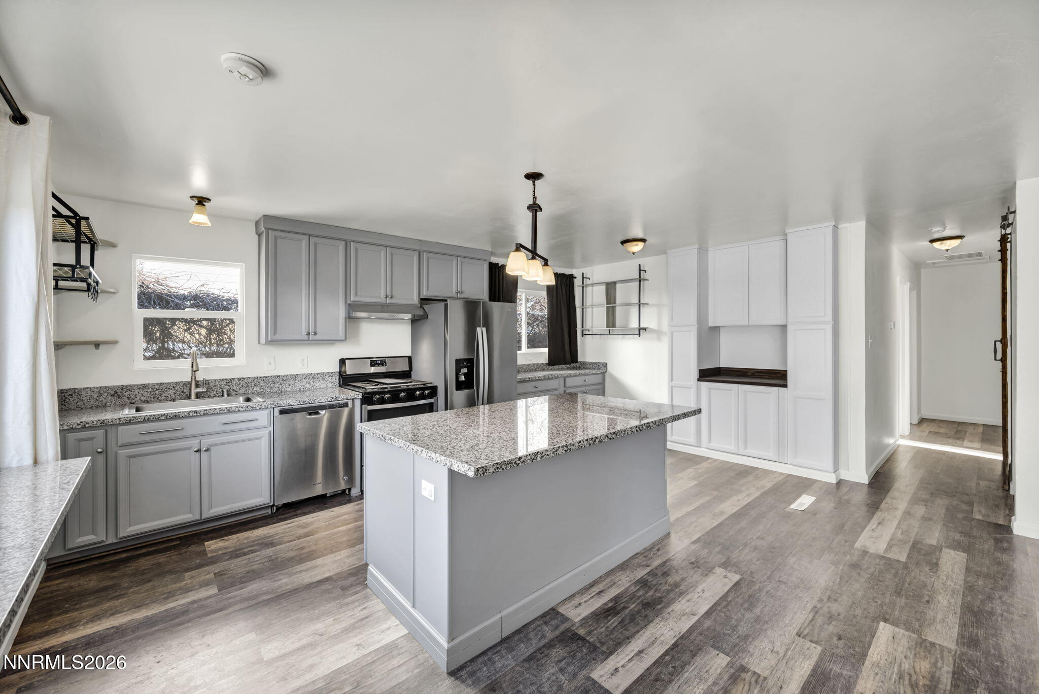 7575 Halifax Drive Reno, NV 89506 - Photo 15 of 58 a large kitchen with stainless steel appliances kitchen island granite countertop a sink stove and refrigerator