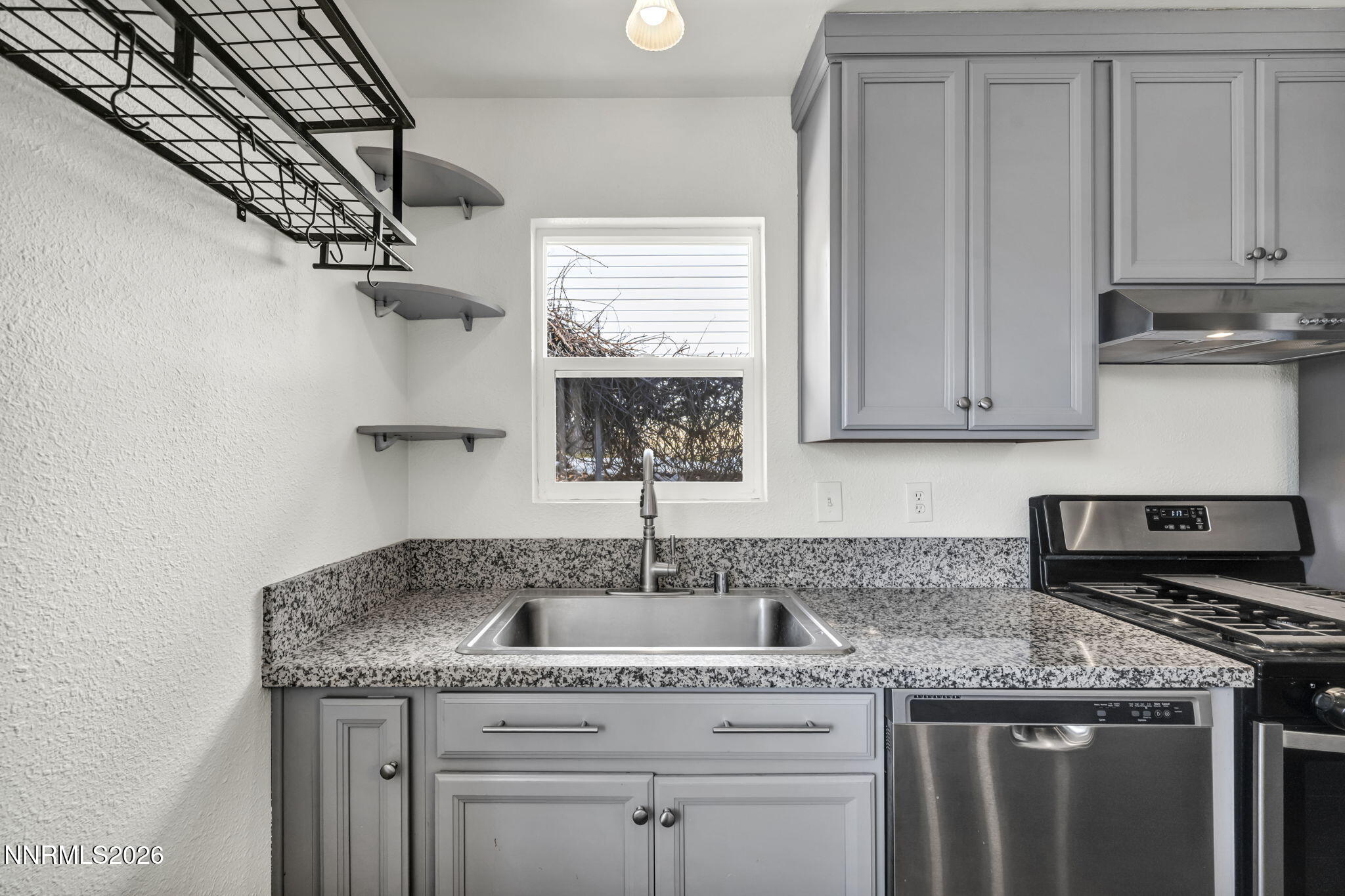 7575 Halifax Drive Reno, NV 89506 - Photo 19 of 58 a kitchen with granite countertop a sink a stove and cabinets