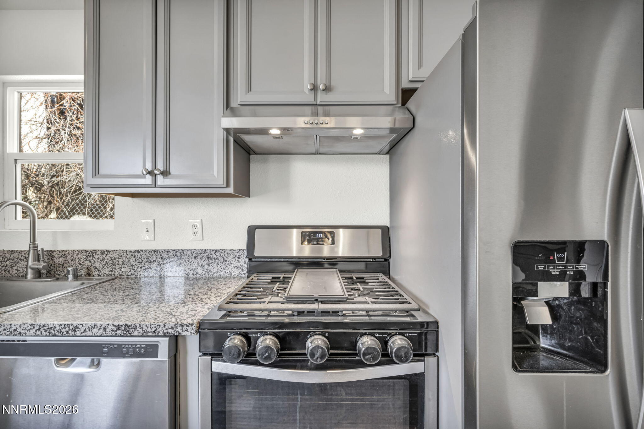 7575 Halifax Drive Reno, NV 89506 - Photo 20 of 58 a kitchen with granite countertop a stove and a sink