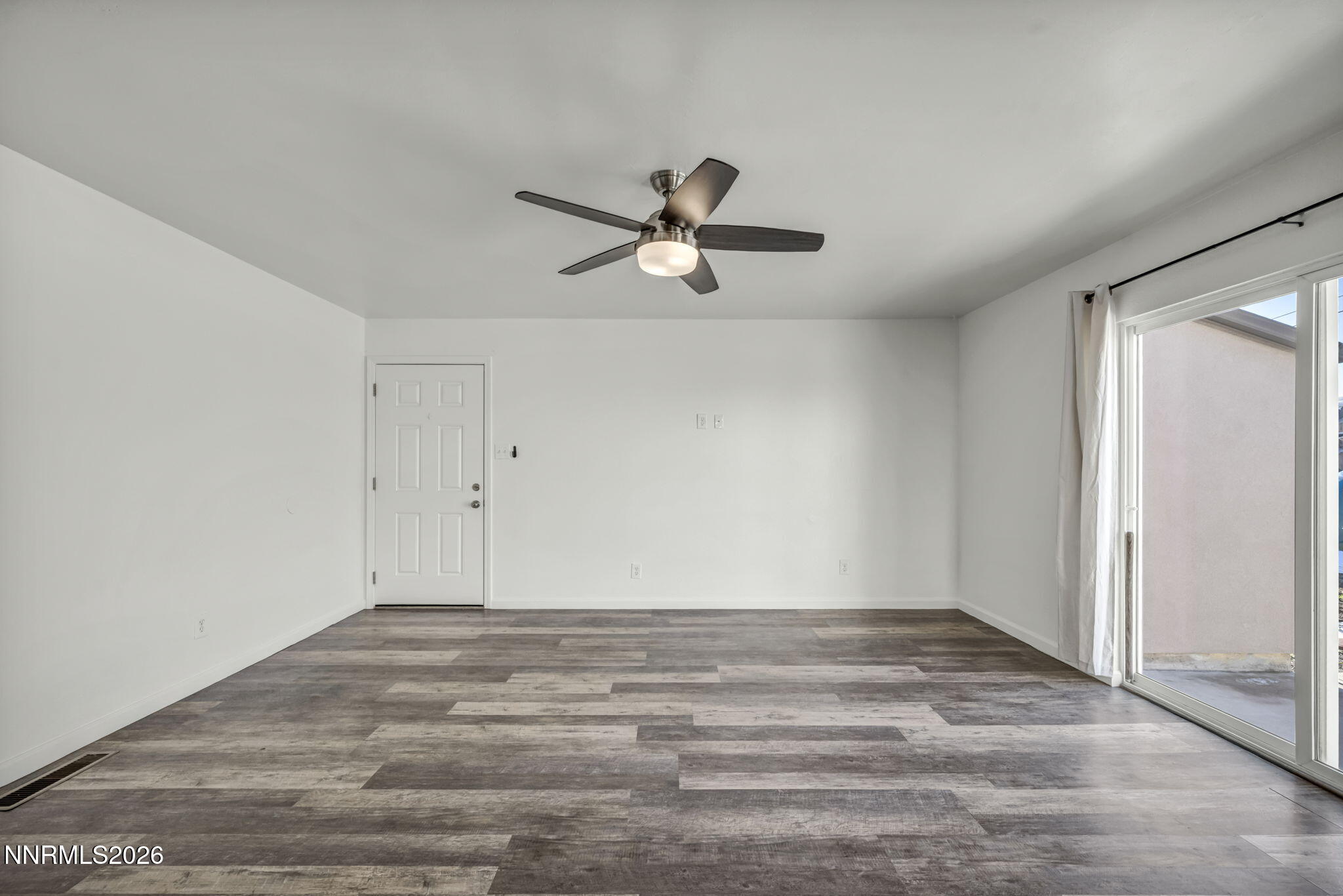 7575 Halifax Drive Reno, NV 89506 - Photo 2 of 58 a view of a room with an empty space and a ceiling fan