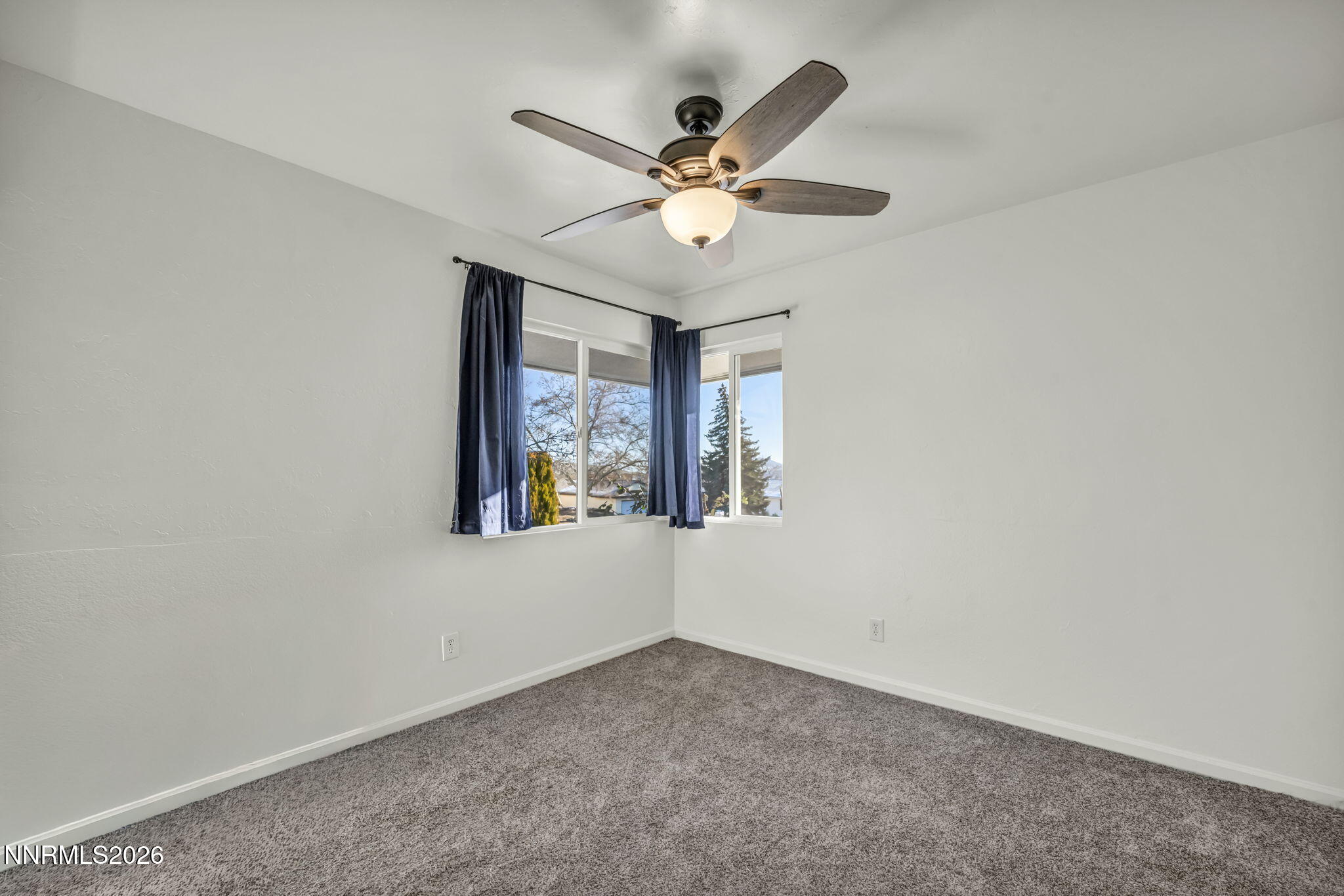 7575 Halifax Drive Reno, NV 89506 - Photo 26 of 58 an empty room with window and ceiling fan