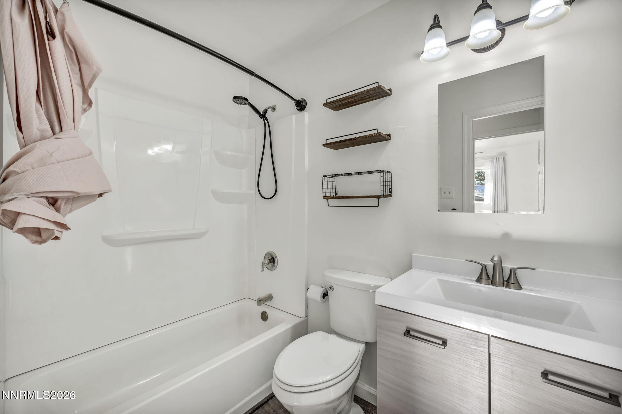 7575 Halifax Drive Reno, NV 89506 - Photo 34 of 58 a bathroom with a sink a toilet a mirror and shower