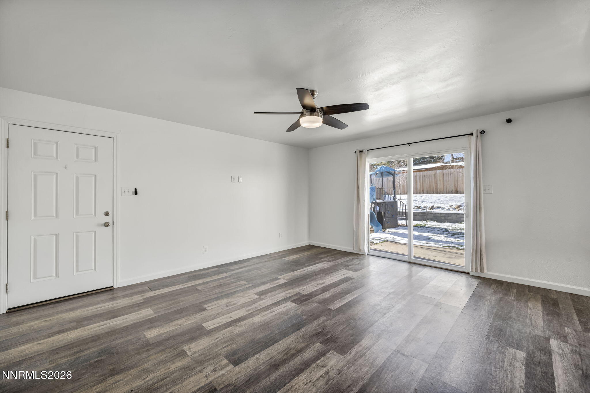 7575 Halifax Drive Reno, NV 89506 - Photo 4 of 58 a view of an empty room with a window and wooden floor