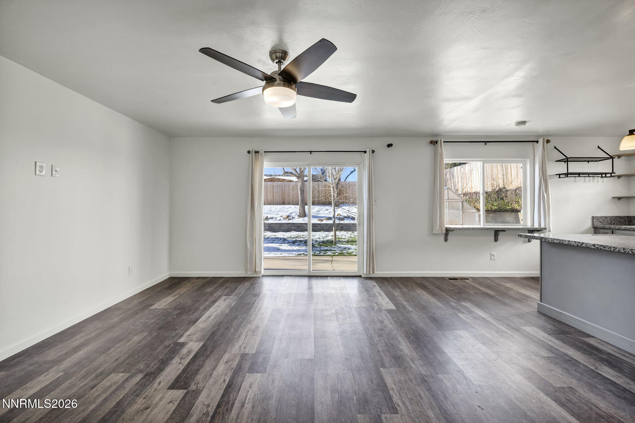 7575 Halifax Drive Reno, NV 89506 - Photo 5 of 58 a view of an empty room with a window and wooden floor