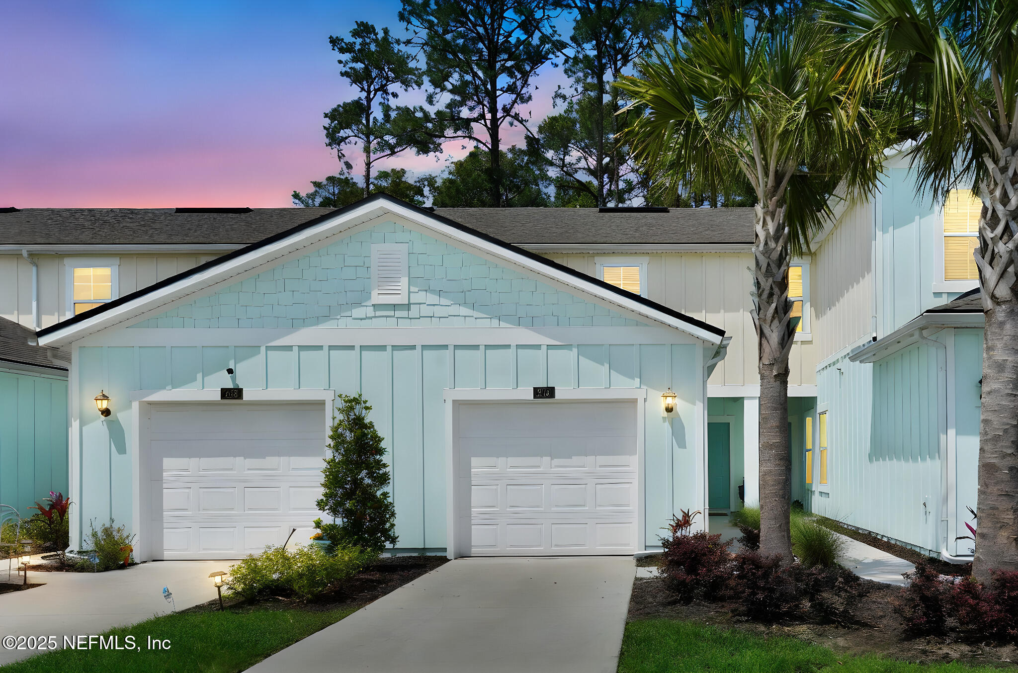a front view of a house with a garden