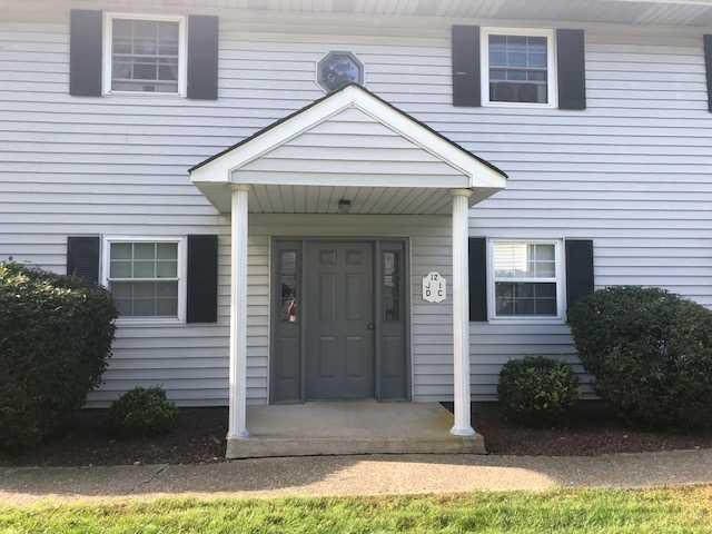 a view of a white house with yard and plants