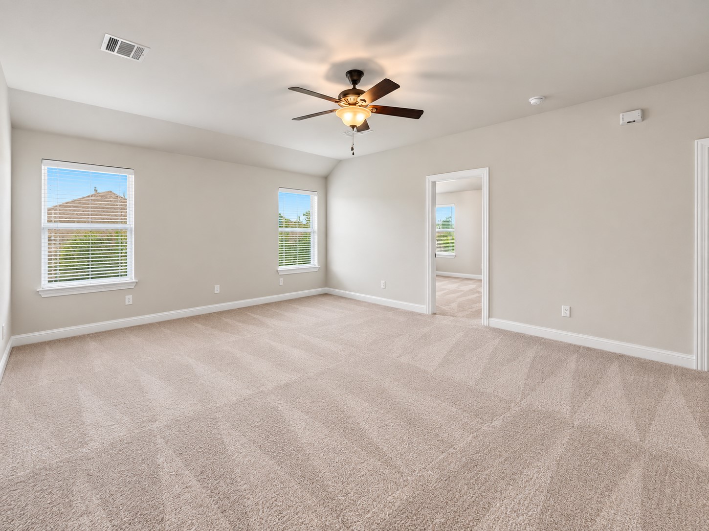 9626 Invergarry Way Tomball, TX 77375 - Photo 23 of 43 Large upstairs game room with multiple windows, ceiling fan, and plenty of room for a variety of entertainment or seating arrangements.