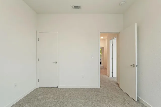 a bedroom with a bed and lamp