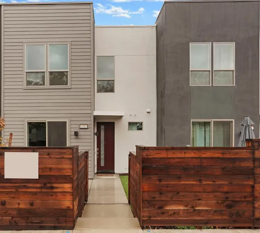 a view of a brick house with large windows