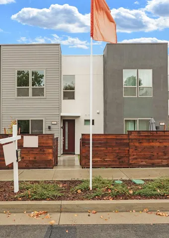 a picture of a living room with a table and chairs
