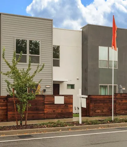a living room with furniture dining area and a large window