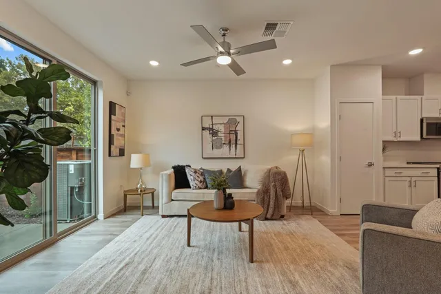 a living room with furniture and kitchen view