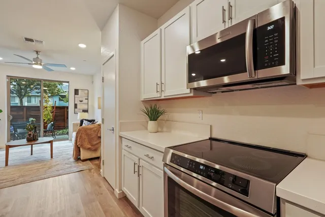 a view of a big room with wooden floor and windows