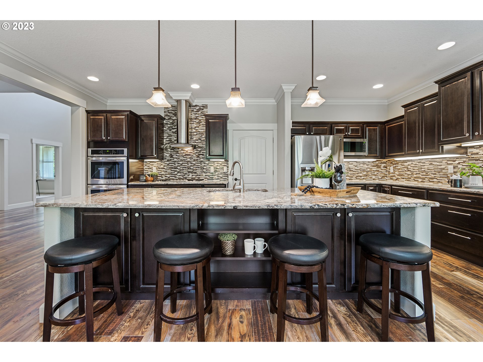 5316 Southwest Childs Road Lake Oswego, OR 97035 - Photo 11 of 42 a kitchen with granite countertop a counter space chairs dining table and chairs