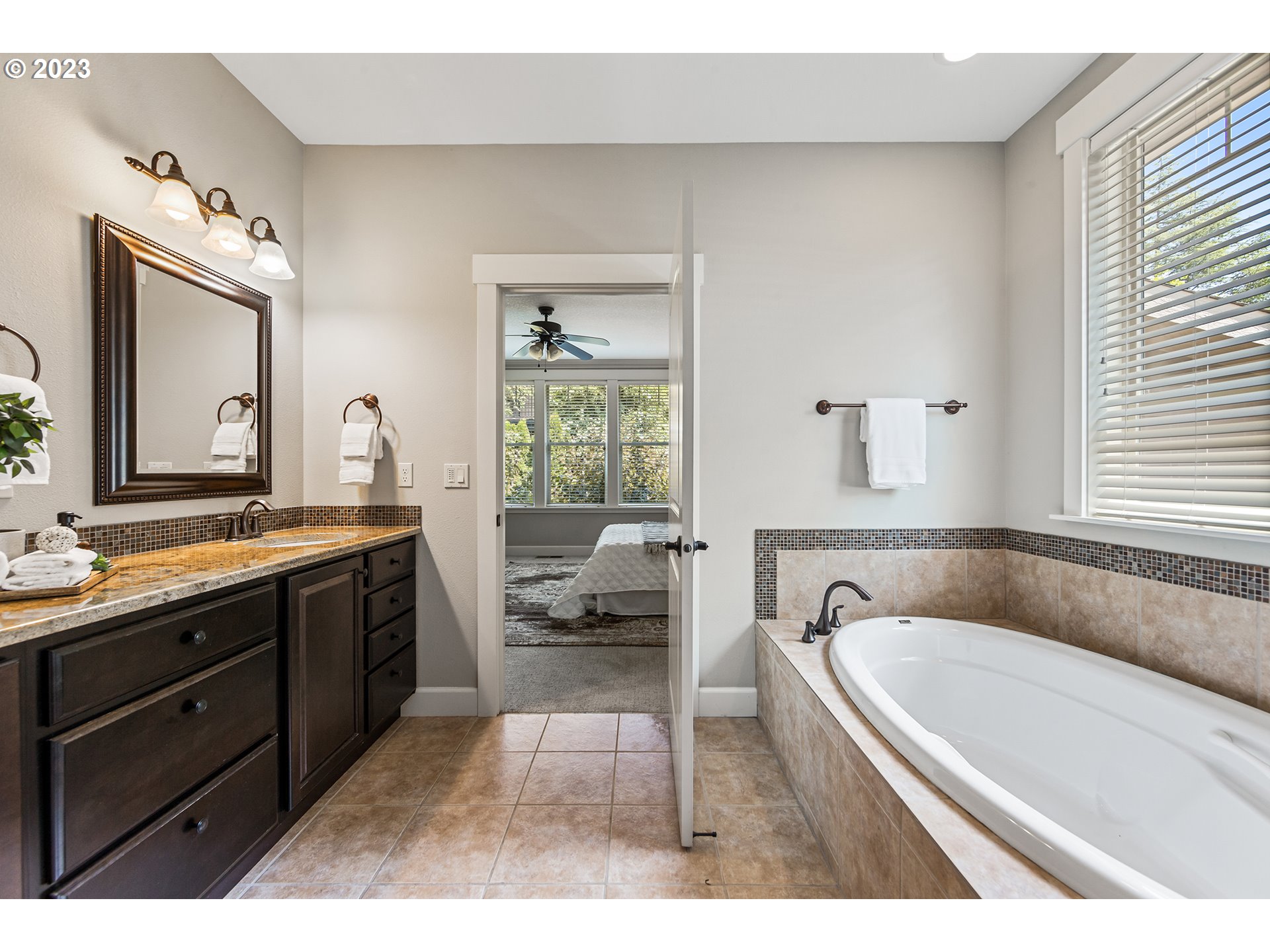 5316 Southwest Childs Road Lake Oswego, OR 97035 - Photo 21 of 42 a spacious bathroom with a granite countertop tub sink and mirror
