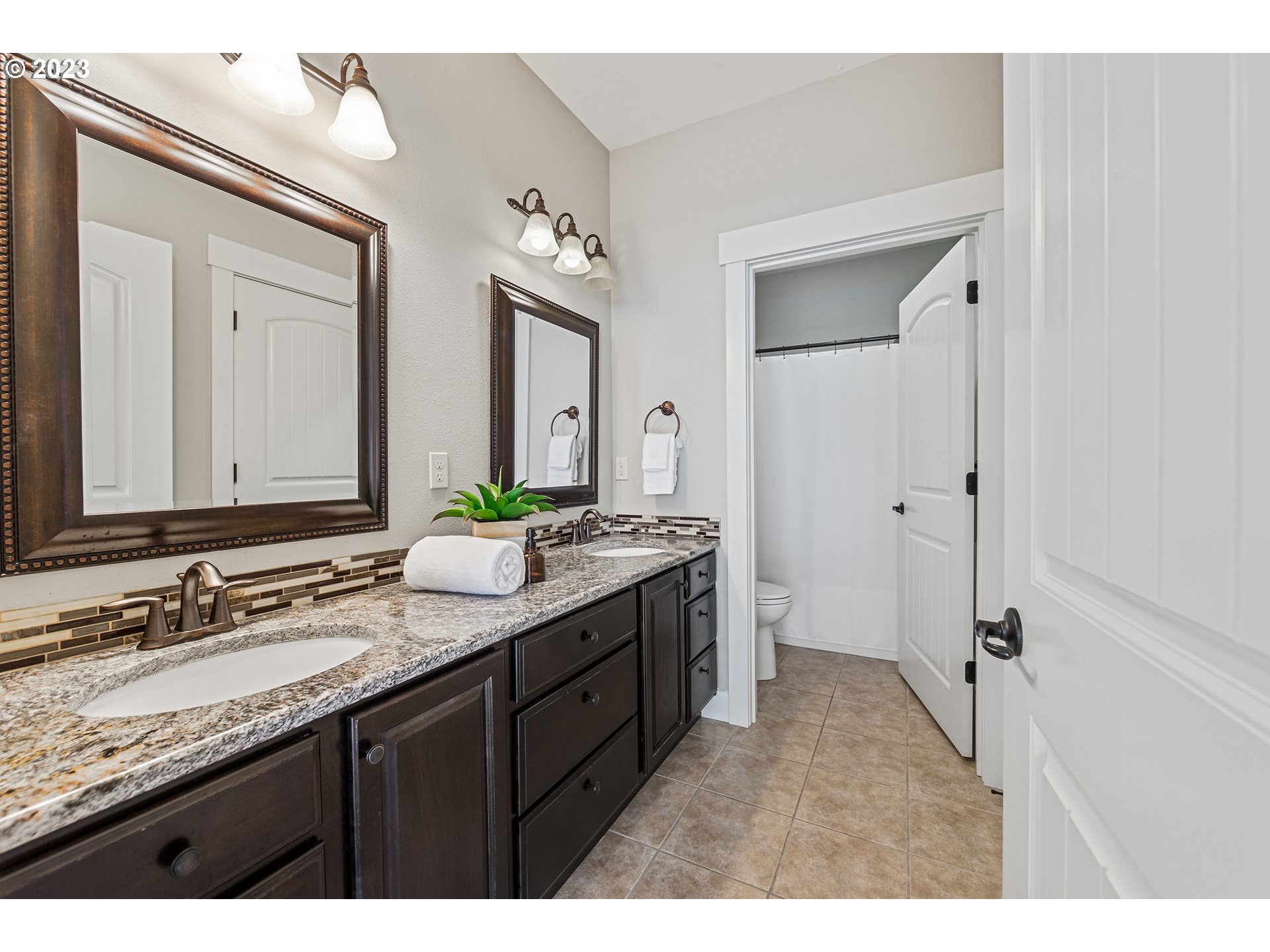 5316 Southwest Childs Road Lake Oswego, OR 97035 - Photo 34 of 42 a bathroom with a granite countertop sink mirror and a