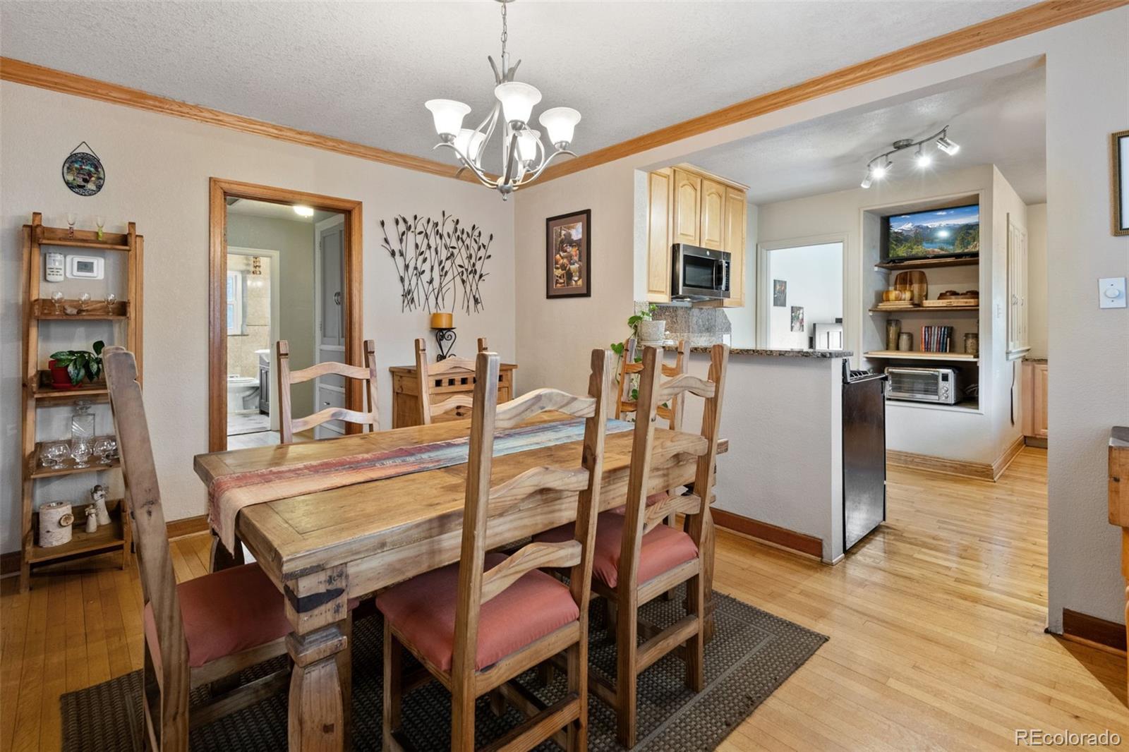 2995 Albion Street Denver, CO 80207 - Photo 11 of 40 a view of a dining room with furniture and wooden floor