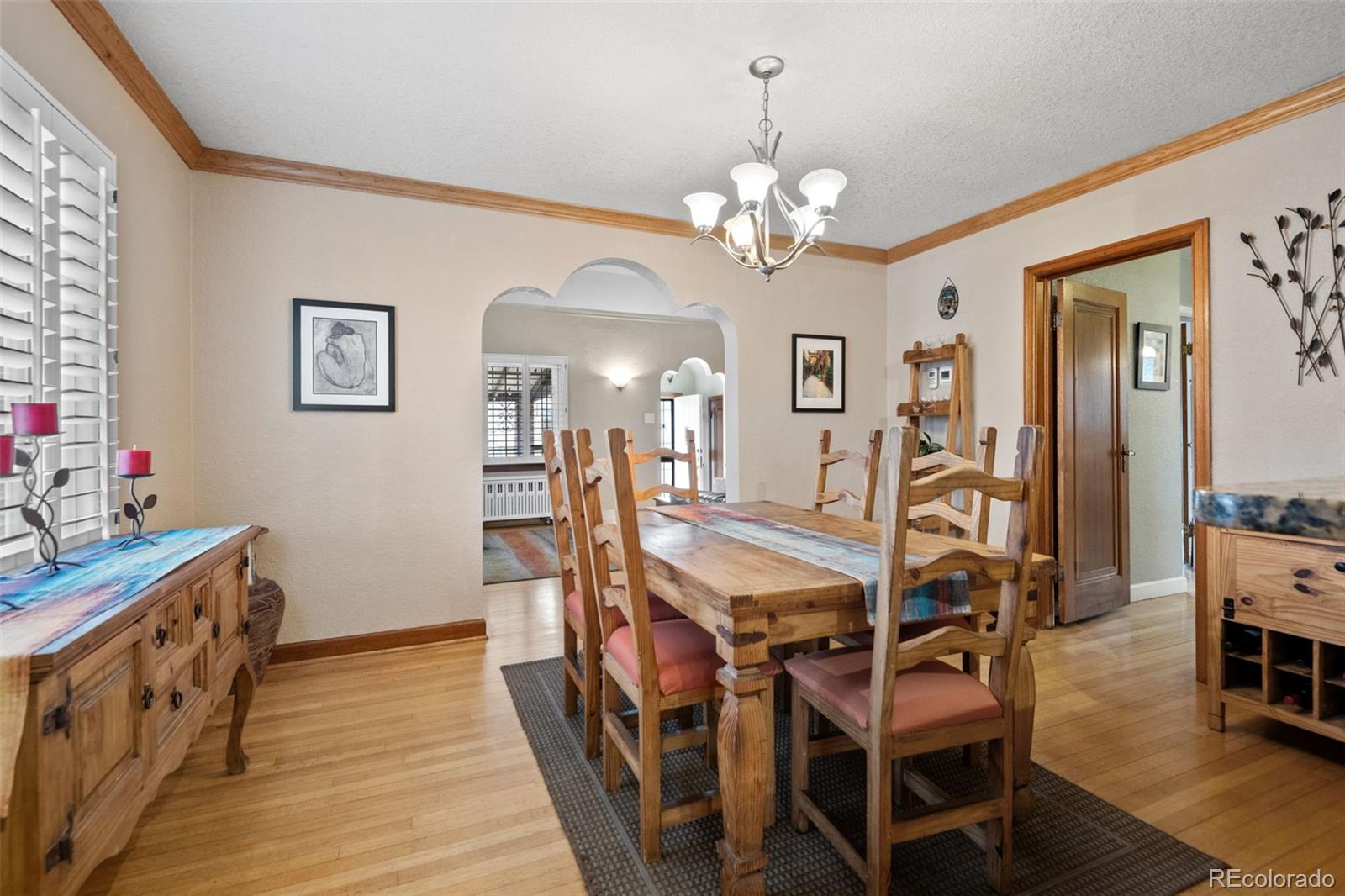 2995 Albion Street Denver, CO 80207 - Photo 13 of 40 a view of a dining room with furniture and wooden floor