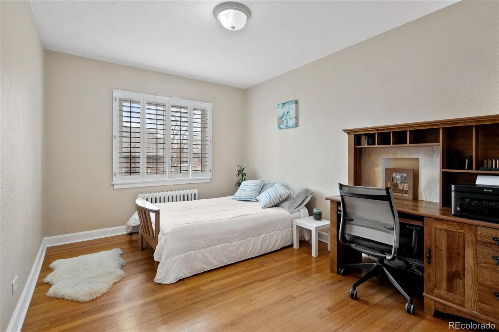 2995 Albion Street Denver, CO 80207 - Photo 20 of 40 a bedroom with a bed and a window