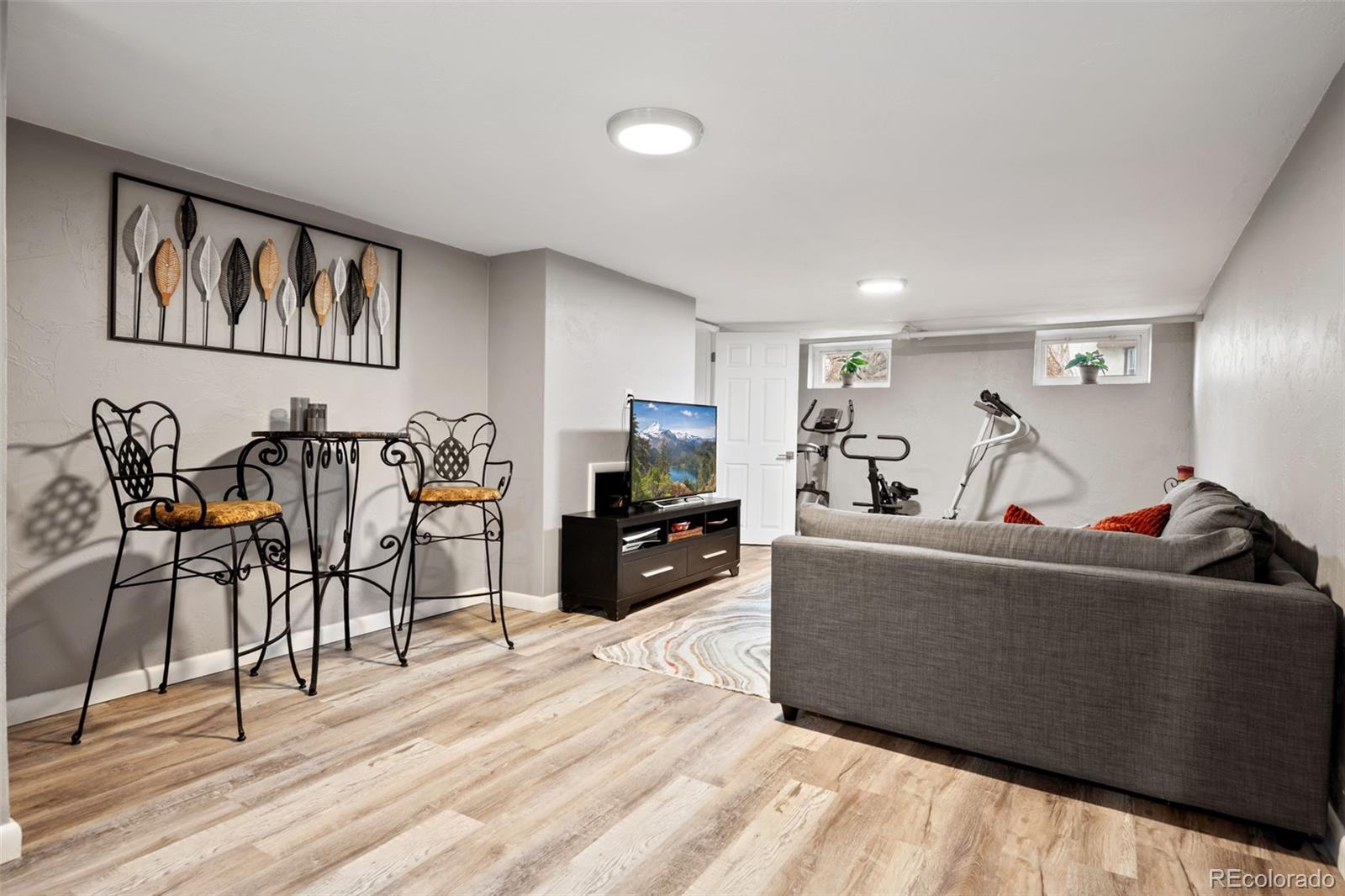 2995 Albion Street Denver, CO 80207 - Photo 24 of 40 a living room with furniture and a flat screen tv
