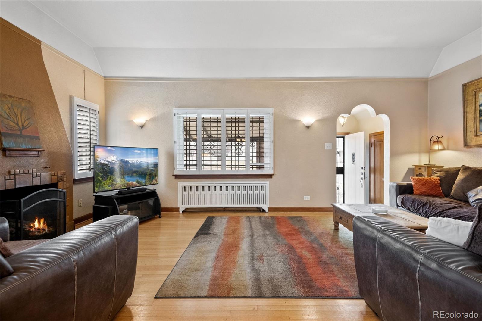 2995 Albion Street Denver, CO 80207 - Photo 7 of 40 a living room with furniture fireplace and flat screen tv