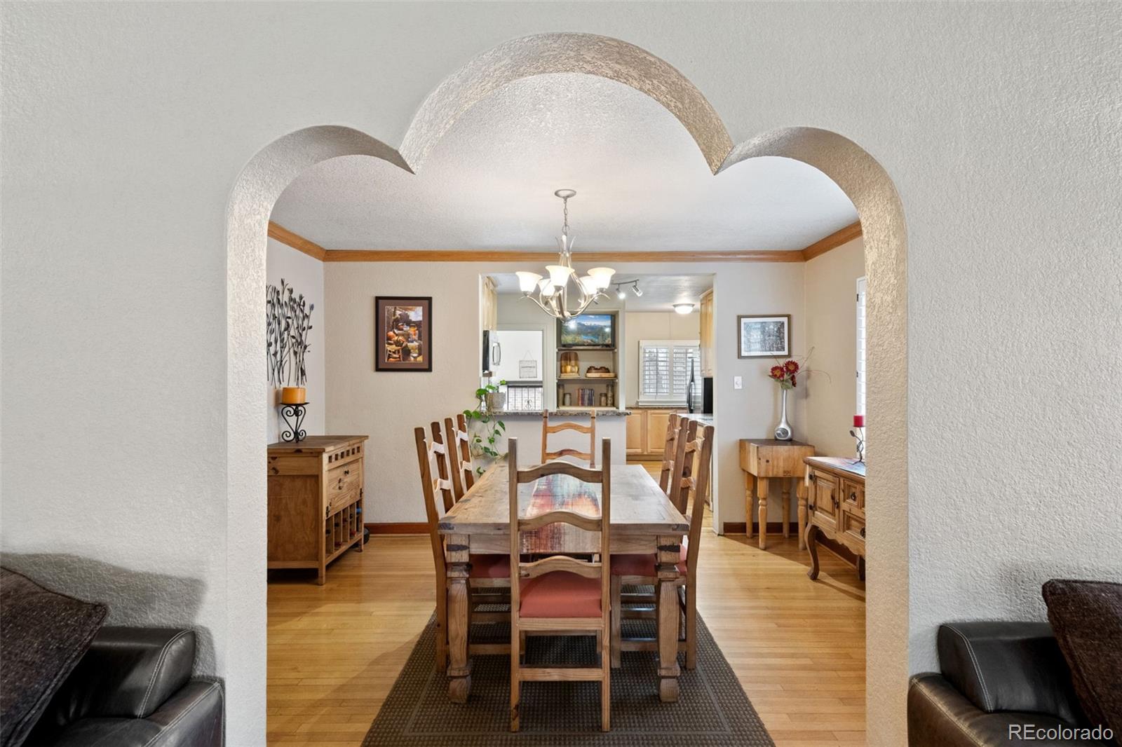 2995 Albion Street Denver, CO 80207 - Photo 10 of 40 a view of a dining room with furniture and chandelier