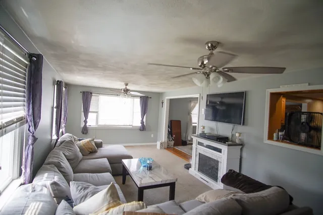 a living room with furniture and a large window