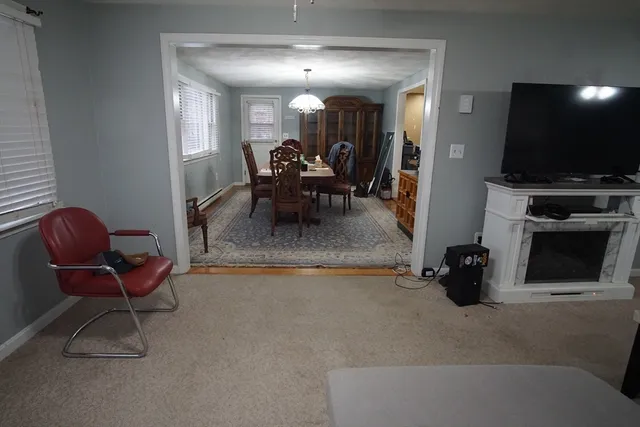 a dining room with furniture and a flat screen tv