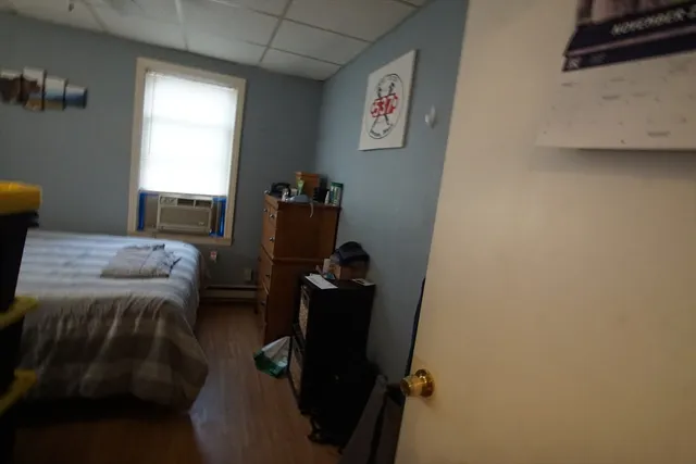 a bedroom with a bed and a window