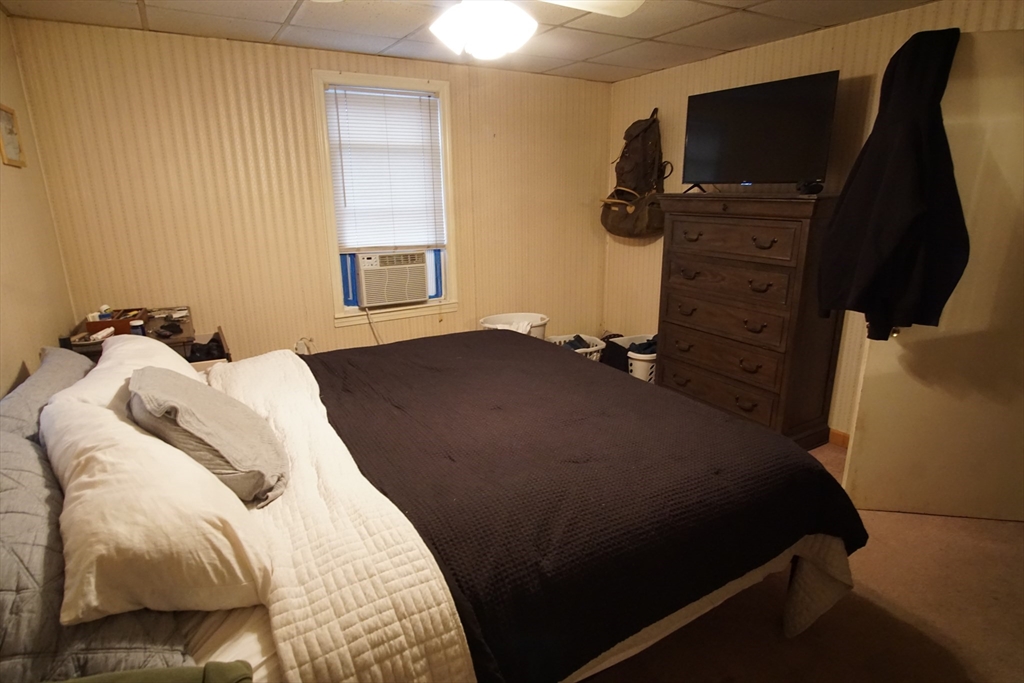 29 Garfield Avenue, Unit 2 Woburn, MA 01801 - Photo 10 of 10 a bedroom with a bed and flat tv screen on the dresser