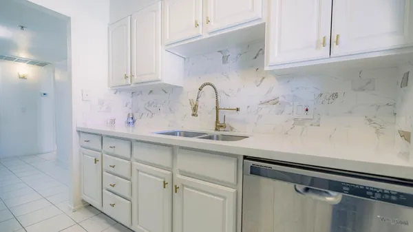 a sink with white cabinets