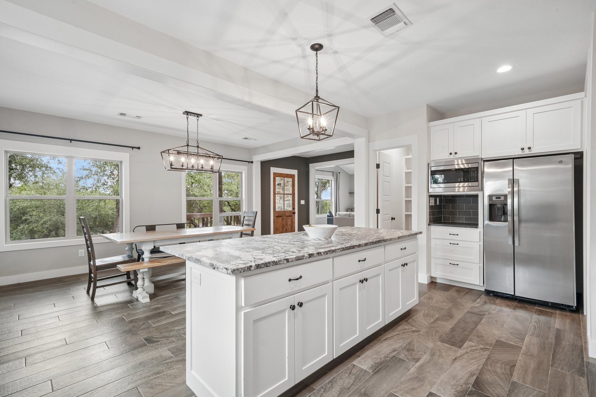 190 Magnolia Meadow Spring Branch, TX 78070 - Photo 2 of 29 A chef's kitchen with a spacious island, gleaming appliances, and ample space for dining.