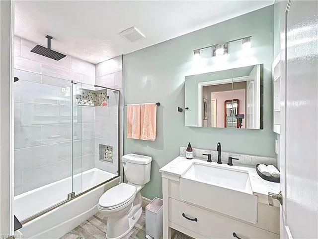 a bathroom with a sink toilet and shower