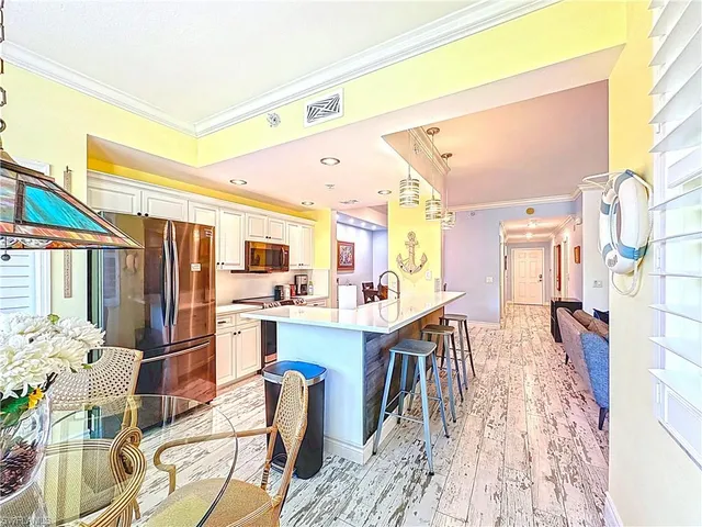 a kitchen with stainless steel appliances granite countertop a refrigerator and microwave