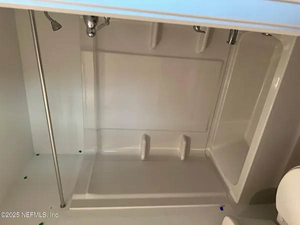 a bathroom with a shower and a sink