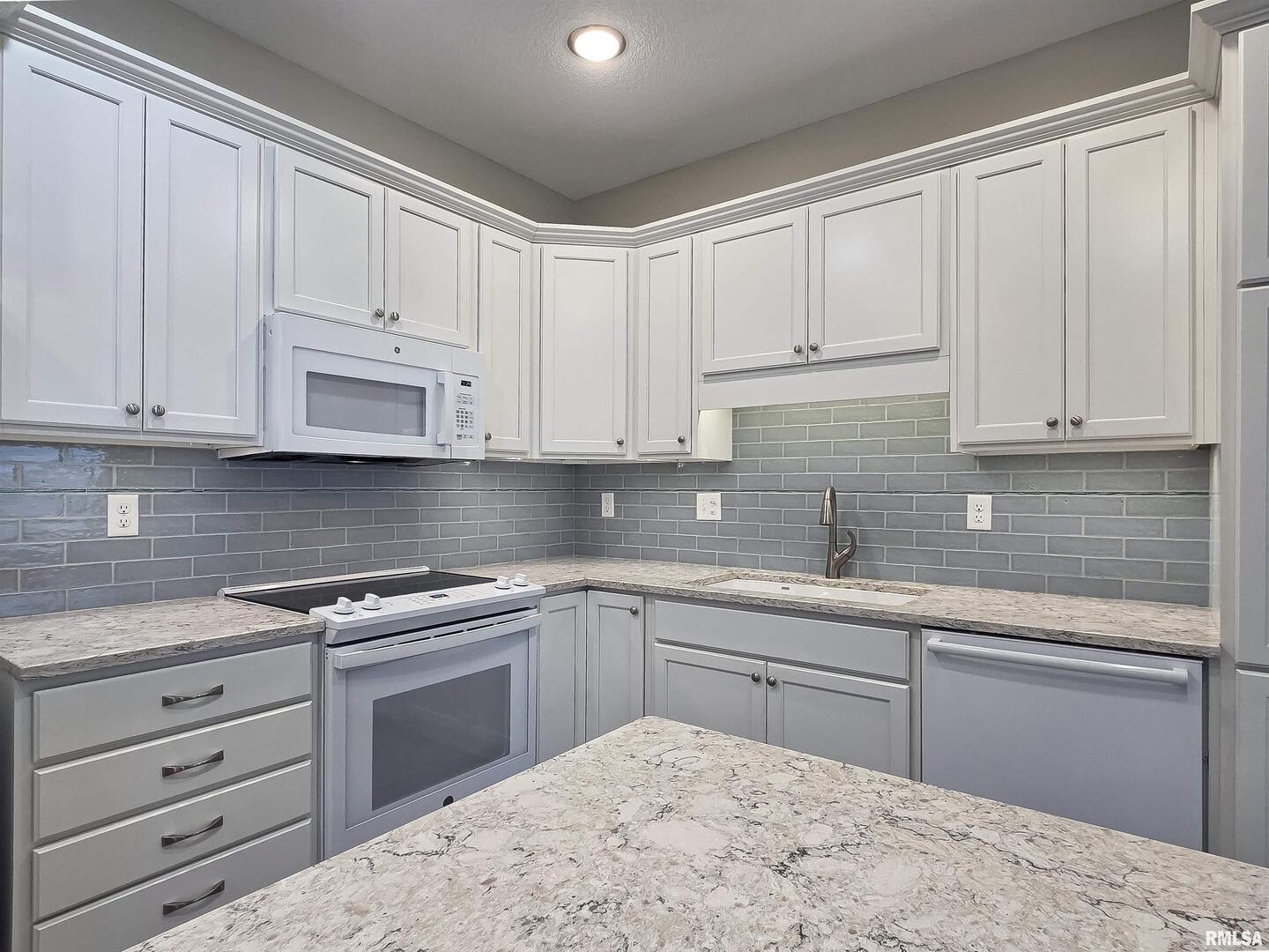 2592 Middle Road, Unit 313 Bettendorf, IA 52722 - Photo 16 of 52 a kitchen with cabinets appliances and a sink