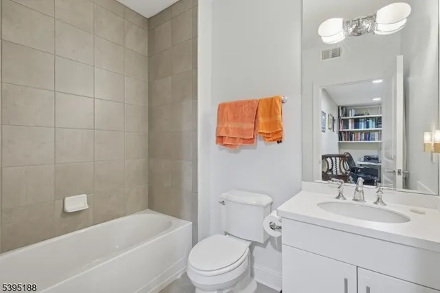 a bathroom with a sink a toilet and bathtub