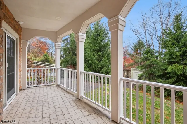 a view of a porch with a floor to ceiling window and wooden fence
