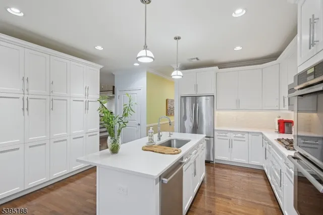 a kitchen with kitchen island a sink appliances and cabinets